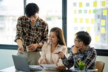 A group of young modern Asians is having a brainstorming meeting while sitting at work. Business meetings, planning, strategy, new business development online business ideas market competition.