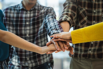 Group of young Asian businessmen business people creative office colleagues happy to succeed in partnership teamwork Celebrate achievements and new contemporary ideas.