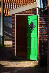 Green wooden door of an old outdoor toilet on a Dutch farm