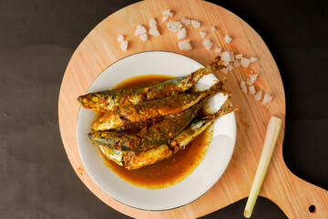 Layang fish cook yellow curry. Authentic Indonesian cuisine. Seafood.