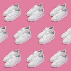 White female sneakers on pink background