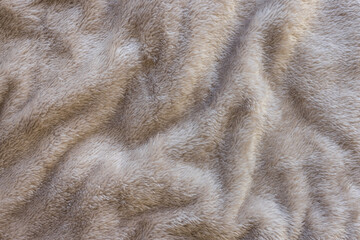 Brown fleece throw blanket. Abstract fabric texture background closeup