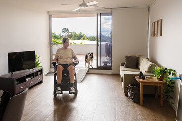 man in wheelchair at home