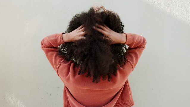 Woman with natural hair and afro curls on white wall background and mockup from the back. Funky, carefree and empowerment girl with natural hairstyle for hair care, style or fashion stylist mock up