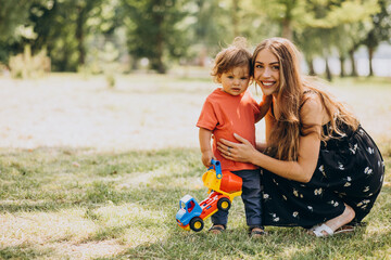 Mother with her little son together in park
