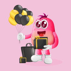 Cute pink monster holding gift box celebrate black friday