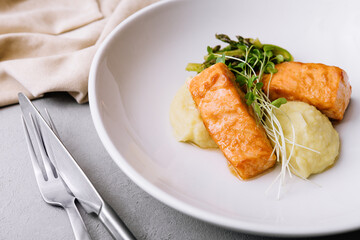 salmon steaks with mashed potatoes on white plate