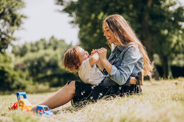 Mother with her little son together in park