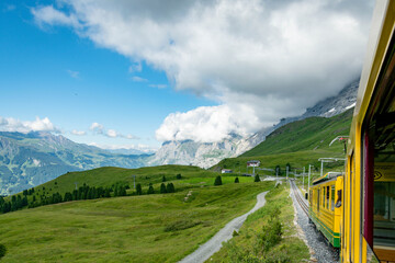 Swiss Alps with train. Beutifull trainride in the Alps. Train with beutifull view and landscape full of mountines. Railway into the mountines in Switzerland.
