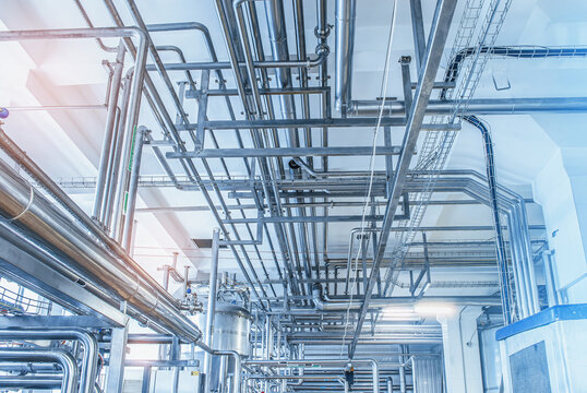 Metal pipes under the ceiling of the milk production plant