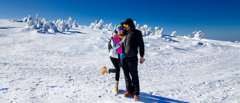 Travelers Couple In The Mountains In Winter. Travel And Active Life Concept With Team. Adventure And Travel In The Mountains Region In Poland.