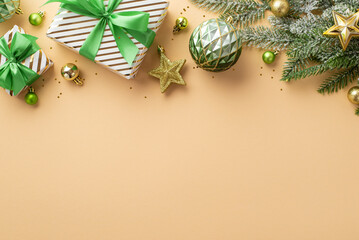 Christmas concept. Top view photo of stylish present boxes with ribbon bows gold and green baubles balls star ornaments confetti and pine branch in frost on isolated beige background with empty space