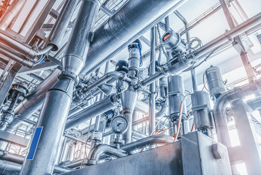Shiny stainless steel metal pipes at a food processing plant, Abstract industry background.
