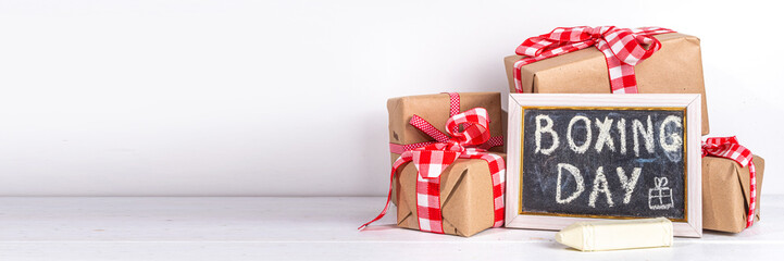 Boxing day sale seasonal promotion background. Various presents box with ribbon, with inscription frame Boxing day, block wooden calendar, wrapping holiday paper, Christmas decor, ribbons