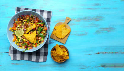 Salad texas caviar. Vegetable dish with corn, beans, pepper, pepper, tomatoes, beans. Served with corn chips nachos. Copy space