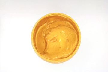 Top view of gold color ink in a bottle, isolated.