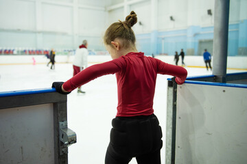 A little girl goes out to the skating rink for a lesson.