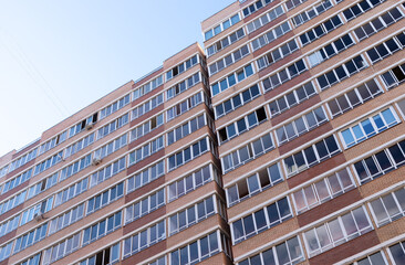 Fototapeta na wymiar High-rise multi-storey building from below, many windows