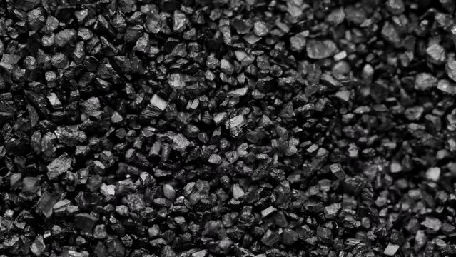 Black sand moving. Close-up of a black sand surface moving.