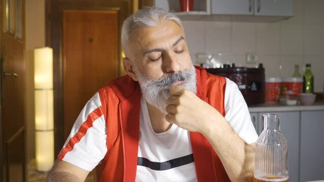 Thoughtful man is drunk and drinking alcohol.
Thoughtful mature man drinks alcohol and becomes distracted.
