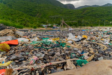 Garbage on the seashore.  The photo was taken in cloudy weather in Vietnam. 