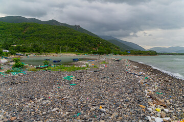 Garbage on the seashore.  The photo was taken in cloudy weather in Vietnam. 