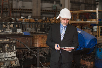Caucasian engineer manager working with spares at factory spares	