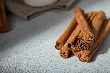 Ceylon cinnamon sticks and ground cinnamon bowl on linen napkin