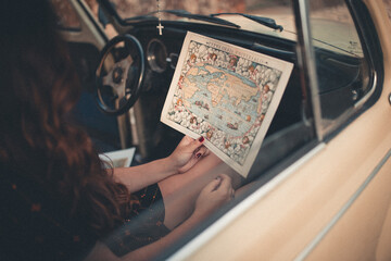 woman in the car with a map