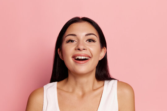 Surprise. Winning success happy woman celebrating being a winner. Image of caucasian female model on pink studio background. Victory, delight concept. Human facial emotions concept.