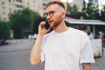 Young man talking on smartphone in city