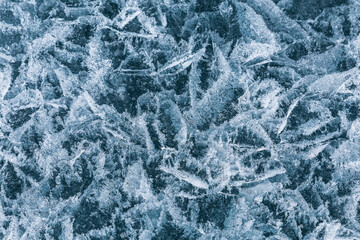 Patterns of air bubbles and cracks on the ice of Lake Baikal, close-up. Irkutsk Region, Eastern Siberia, Russia