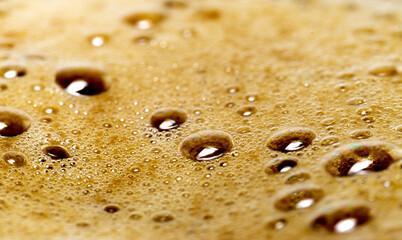 close-up brown foam with bubbles on cappucino