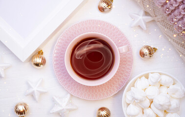  Winter, Christmas, New Year decoration composition, concept, background. White Mug, cup of hot tea, coffee, meringue, knitted plaid. Christmas lights. Christmas mood morning. Christmas  card.