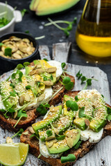 avocado toasts with cheese, pumpkin, nut and sesame. Healthy fats, clean eating for weight loss