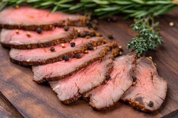 Fototapeta premium a piece of grilled meat sliced on a wooden board