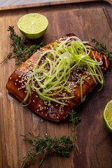 salmon steak in grilled sauce on a wooden board