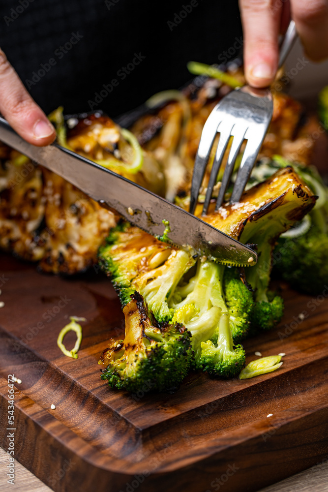 Wall mural grilled cauliflower on a wooden board.