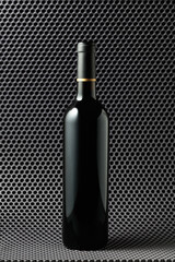 Bottle of red wine on a grey background.