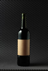 Bottle of red wine on a grey cellular background.