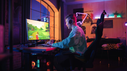 Successful Gamer Playing and Winning in PvP Shooter Video Game in Which Players Fight in a Battle...