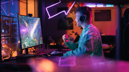 Successful Gamer Playing and Winning in PvP RPG Strategy Video Game in Which Players Fight in a Battle Royale Tournament on Personal Computer. Stylish Man Celebrating Victory in Cozy Room at Home. © Gorodenkoff