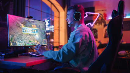 Successful Gamer Playing and Winning in PvP RPG Strategy Video Game in Which Players Fight in a Battle Royale Tournament on Personal Computer. Stylish Man Celebrating Victory in Cozy Room at Home.