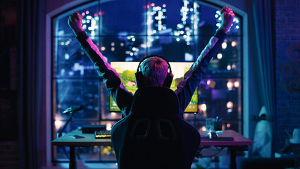 Successful Young Female Professional Gamer Winning in a Video Game on Personal Computer in a Neon Lit Living Room at Home. Online Internet Championship Tournament Winner  © Gorodenkoff