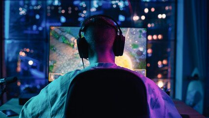 Back of the Head Angle of a Successful Gamer Playing a Video Game on Powerful Personal Computer in...
