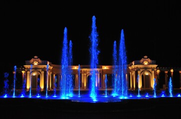 fuente con agua iluminada de azul por la noche