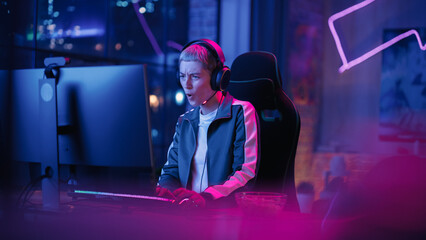 Attractive Female Gamer Playing Online Video Game on Computer. Portrait of Slightly Stressed Woman...