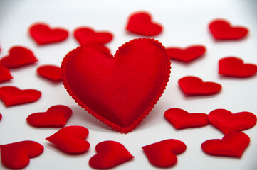 Big heart shape surrounded with other small heart shape on white cover background. With customizable space for text and ideas.