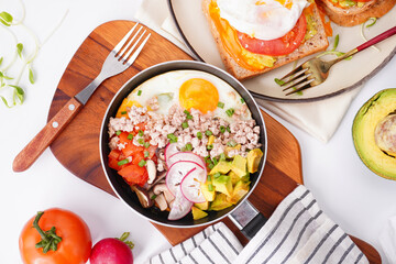 Breakfast fried eggs in a pan on a white background