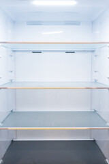 Completely empty fridge with compartments and ceiling light